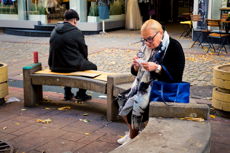 An elderly man analyzing a slip of paper by Jukka Heinovirta